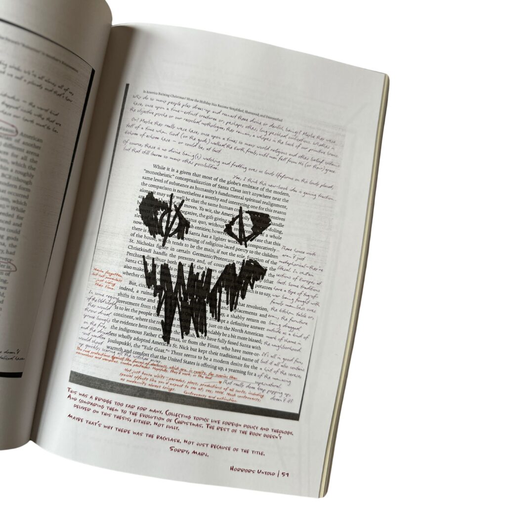 An open page from Horrors Untold, an immersive guide about Halloween Horror Nights. The page is densely filled with typed text and handwritten notes in red and black ink, resembling editorial annotations. A large, dark graffiti-style drawing of an evil face overlays the center, featuring two eye-like shapes above jagged mouth. At the bottom, a handwritten note in red ink critiques the page’s thematic execution and includes a signature-style apology. The book is just the beginning. This is the introduction of the Horrors Untold Blog.