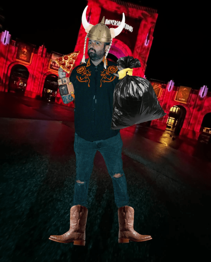 Nick from the Fear and Beer podcast, wears cowboy boots, and a western shirt, a Pip-boy on his wrist from the video game Fallout, pizza, and a Vikings hat holding a trash bag in a mockup photo placed in front of Universal Studios entrance for Halloween Horror Nights.